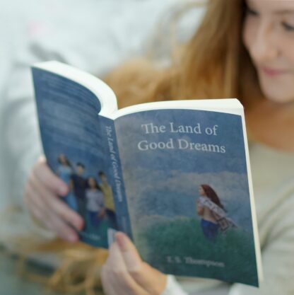 Teenager girl reading the Land of Good Dreams book 1