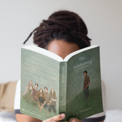 woman holding book The Awakening open wide